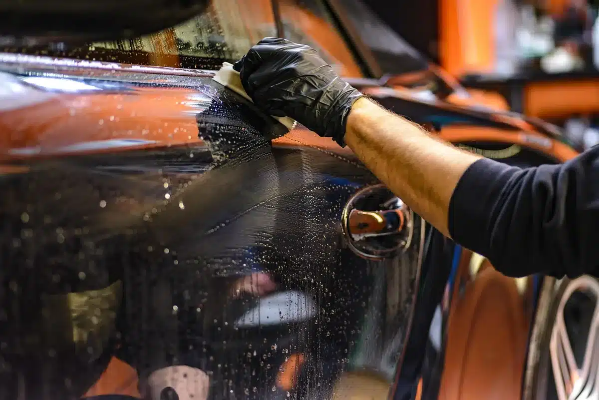 Microfibre et nettoyant sur une surface plastique de voiture